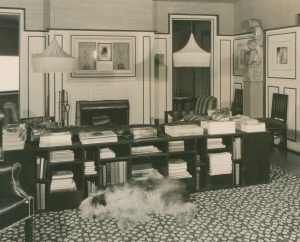 Black and white photo of an office with the same floral carpet design as the Wormser bedroom.
