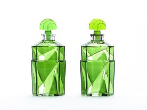 Pair of rectangular, bright green glass bottles cut in a way that refracts light in a triangular pattern. Bottle stoppers are fan-shaped in solid green glass.