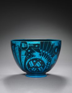 A dark blue bowl with light blue markings depicting various elements from the era's style.