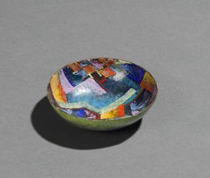 Small dish decorated with colorful, patchwork-like shapes.