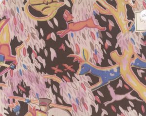 Textile design sample featuring dogs, deer and figures on horseback leaping through fall leaves in pink, blue and orange.
