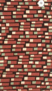 Textile design sample featuring dark red rectangles stacked like bricks with green and white squares on their leftmost ends.