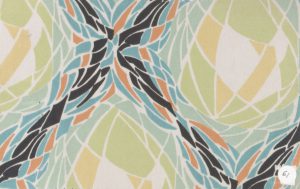 Textile design sample featuring geometric forms in light blue, orange, black, yellow, white, and green loosely arranged to look like blooming flowers.