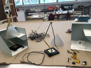 Two desk lamps in the process of being deconstructed and rewired in the museum’s conservation lab.