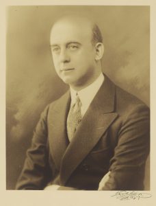 Sepia-toned portrait of Leo Wormser in a suit, in three-quarter profile.