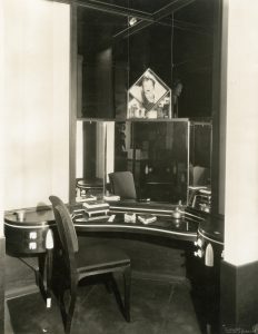 Black and white photo of a curved black dressing table in an interior designed by Joseph Urban.