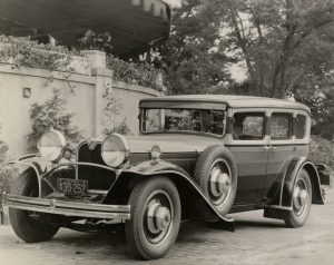 Black and white photo of a 1929 Ruxton automobile displaying the car’s elongated front and horizontal striping.