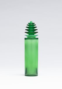Skinny green glass bottle with a pagoda-shaped stopper.